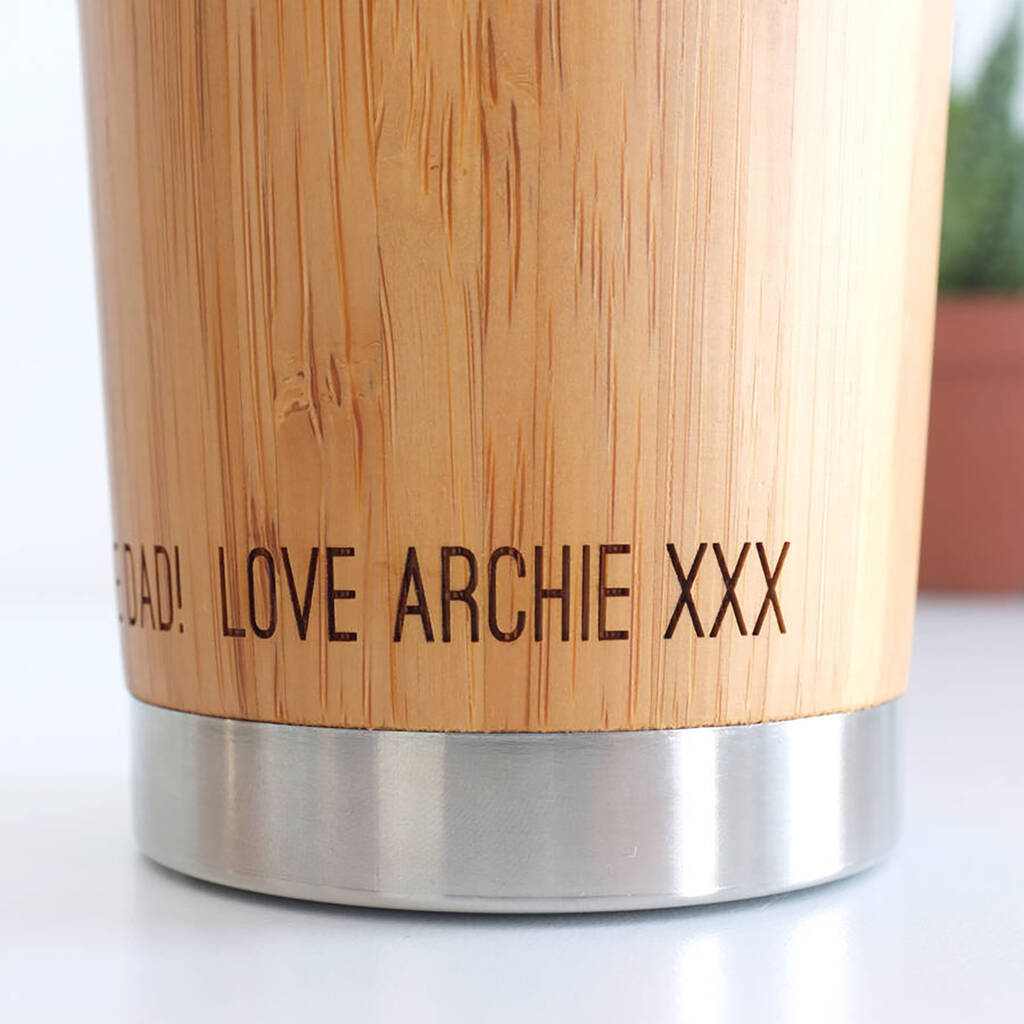 Close up image of text etched on the bamboo travel mug