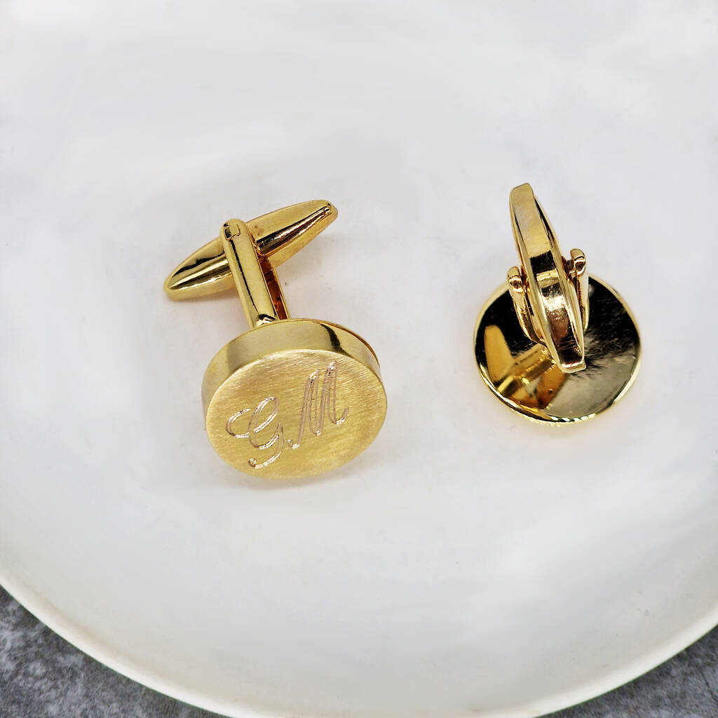 gold cufflinks engraved with script font