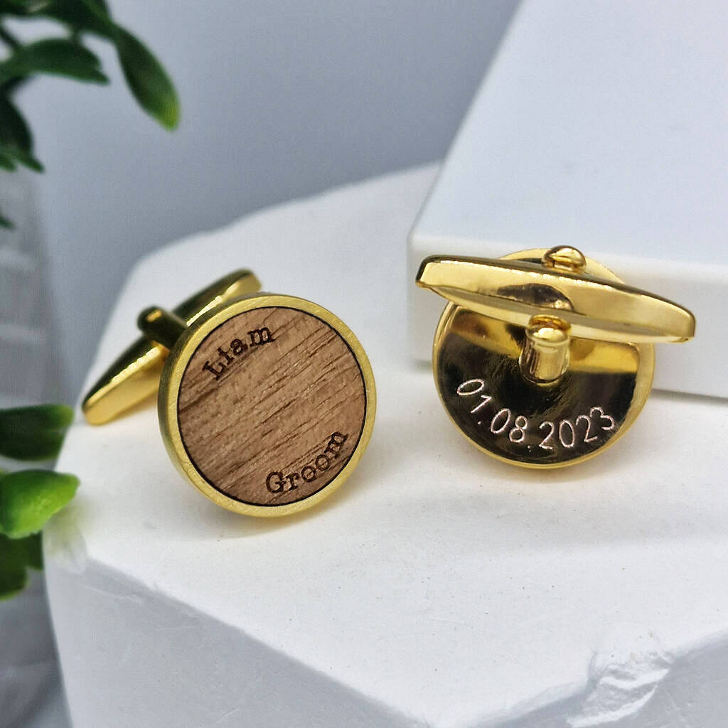 Two gold walnut cufflinks, one etched with text on the front and the other engraved with text on the back